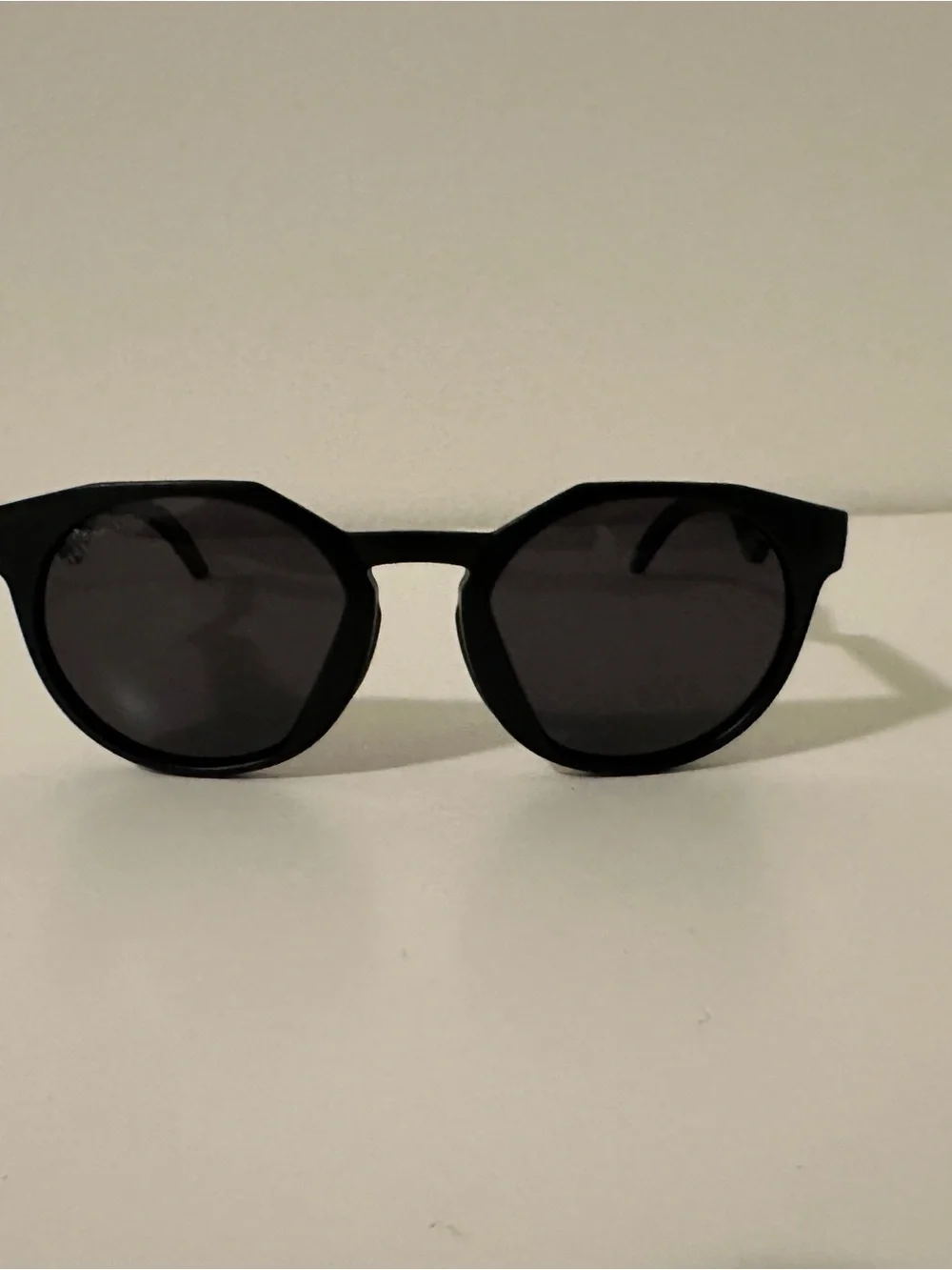 Oakley Black Round Sunglasses with Zigzag Temples and White Logo Accents